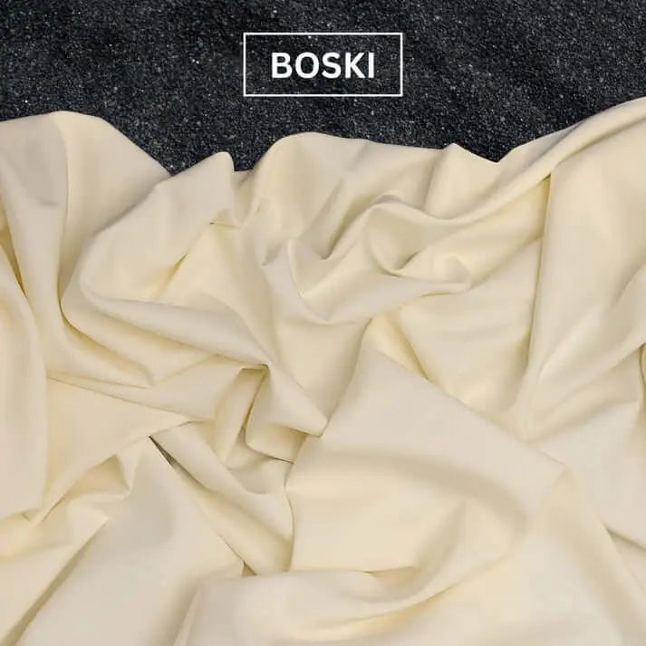 Soft cream-colored Boski fabric spread on a dark textured surface